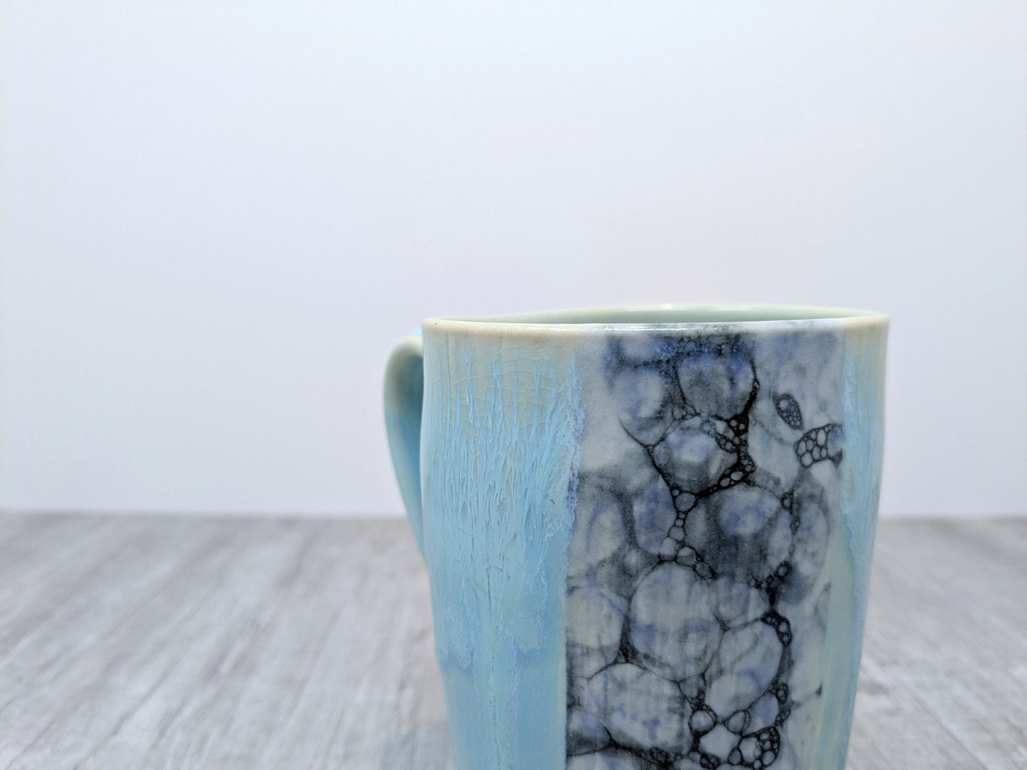 Blue Drip Glaze Pottery Mug with Abstract Pebble Design