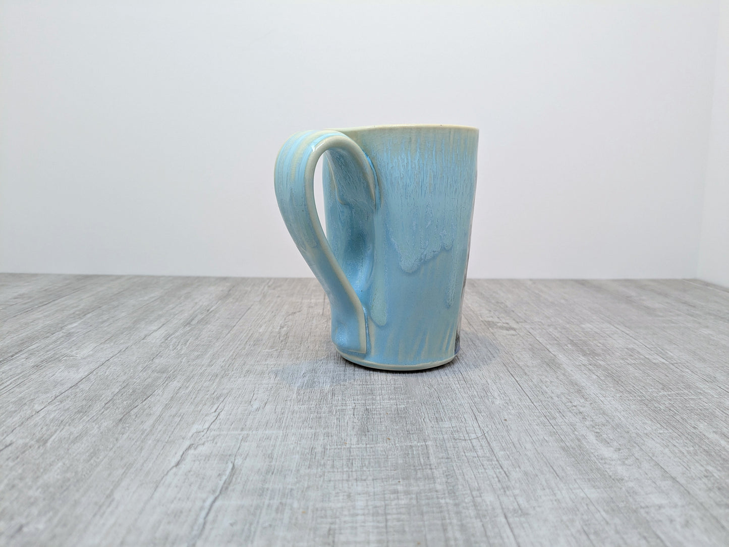 Blue Drip Glaze Pottery Mug with Abstract Pebble Design