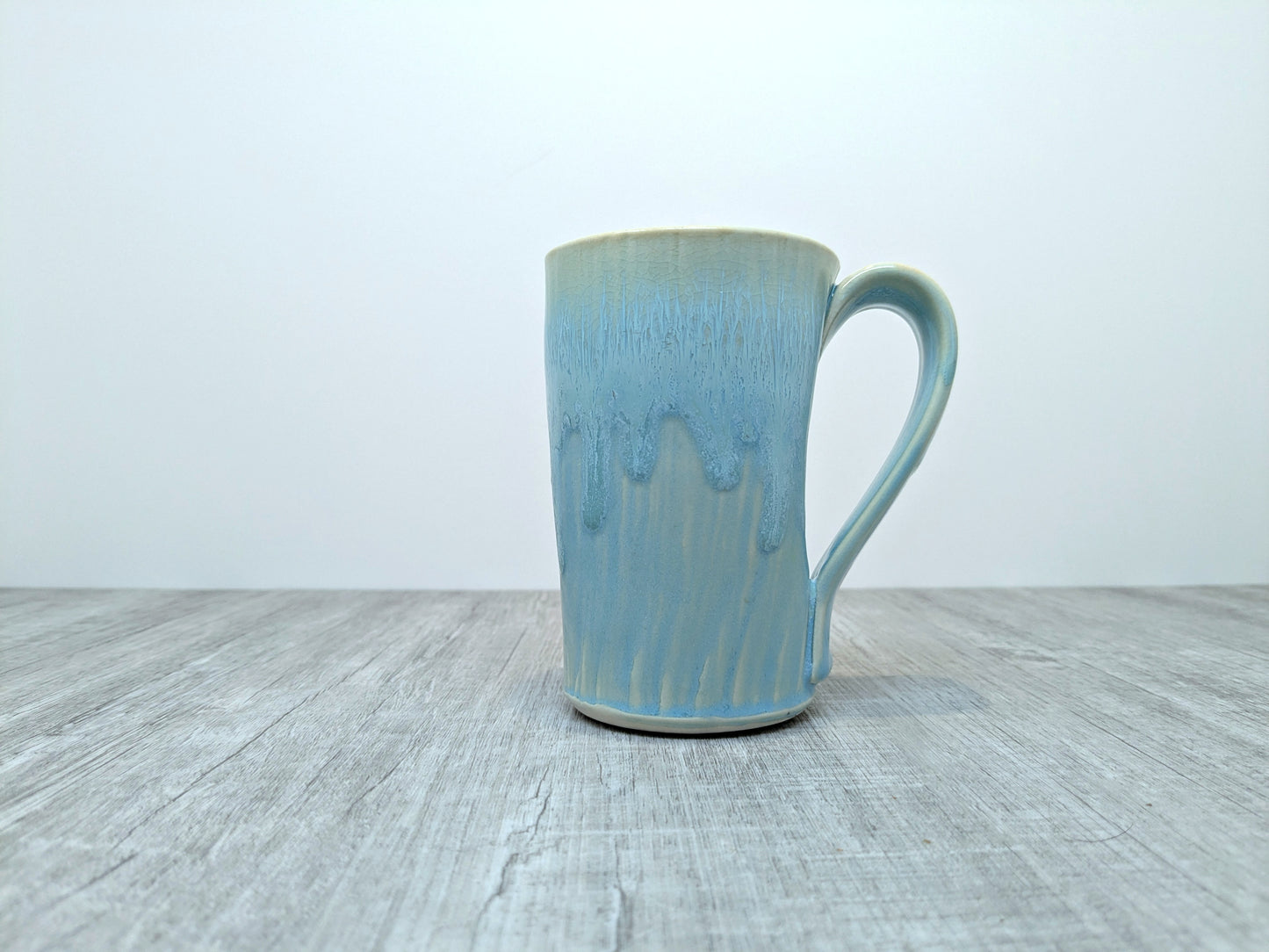 Blue Drip Glaze Pottery Mug with Abstract Pebble Design